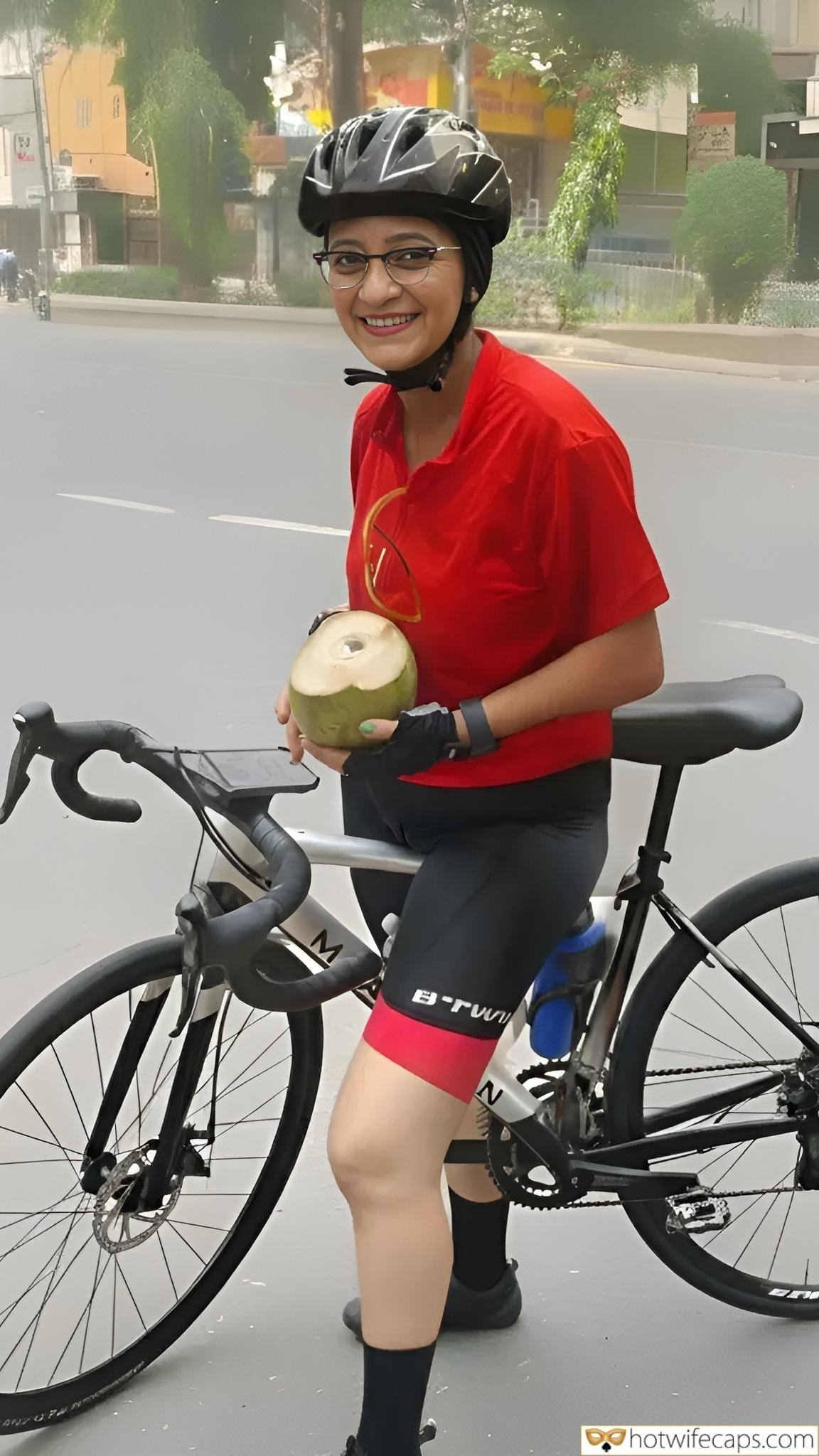 Submitted by Users 🔥 Public Humiliation Flashing hotwife caption: A cyclist in urban attire, wearing tight cycling tights, stands confidently on a city street, holding a bicycle and a coconut. Her vibrant red shirt con... Public Display: My Hotwife’s Accidental Cameltoe While Cycling