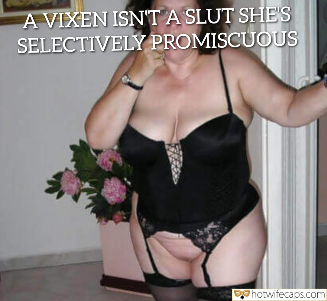 Wife Sharing Submitted by Users 🔥 Cuckold Stories Cheating hotwife caption: A woman in black lingerie stands confidently, holding flowers and a brownie, embodying selective promiscuity in a private indoor setting. Selective Promiscuity: The Art of the Vixen